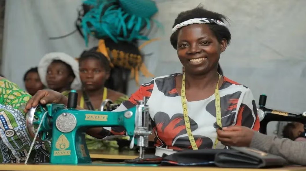 F.T & Foundation's sewing classes program help empower vulnerable lives in Congo Woman in Congo smiling while learning sewing skills.
